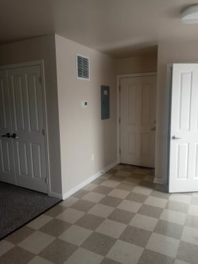 an empty room with a checkered floor