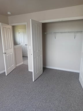 a bedroom with a closet and a door open