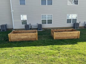 a couple of raised garden beds in the back of a house