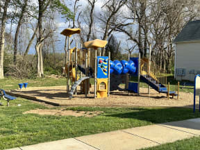 a playground with a blue and yellow playset