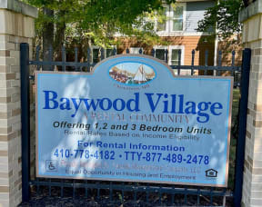 a sign on a fence in front of a building