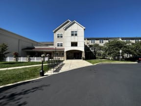 a house on a street with a blue sky in the background