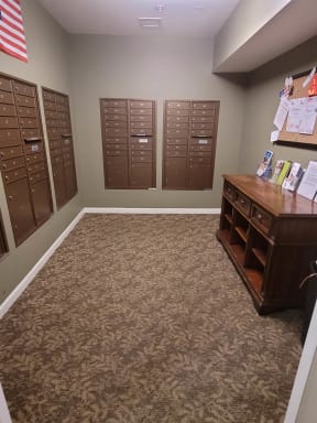 a room with lockers and a dresser with an american flag on the wall