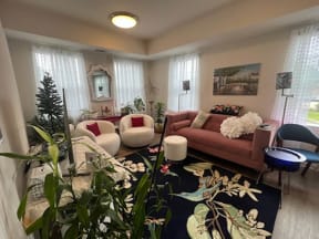 a living room filled with furniture and a large rug