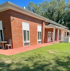 a brick building with a lawn in front of it