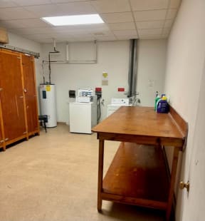 a room with a table and a refrigerator in it