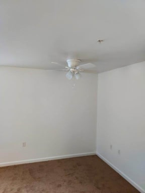a white room with a white ceiling fan