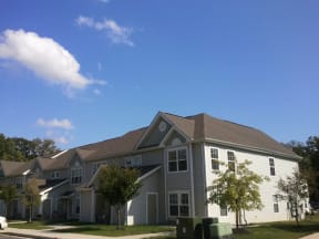 a gray house with a gray roof on a sunny day