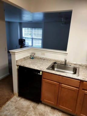a kitchen with a sink and a window