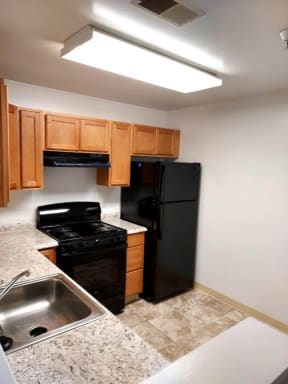 a kitchen with a sink a stove and a refrigerator