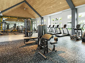 A gym with a variety of equipment including treadmills, weights, and exercise machines.