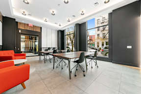 a conference room with a large window and a table and chairs