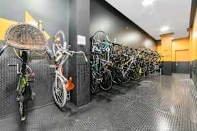 a row of bikes parked in a parking garage