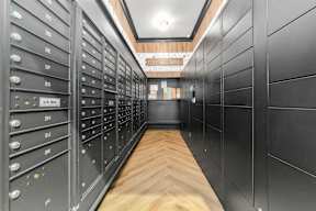 a lockers room with wooden floors and black cabinets