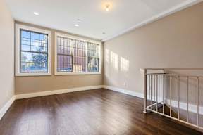 A room with a window and a railing.