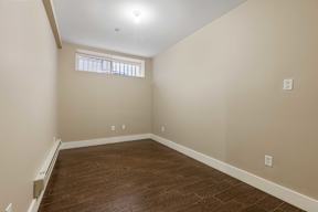 A room with wooden floors and a window.