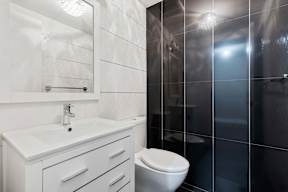 A white sink and toilet in a bathroom.