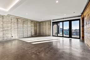 A large empty room with concrete walls and floors.