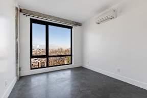 A room with a large window and a sliding door.