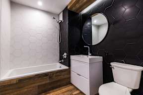 A white toilet sits next to a sink in a bathroom.