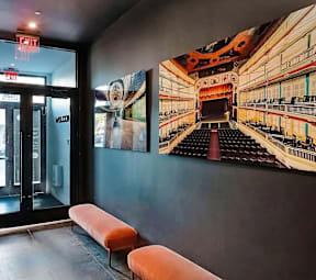 A theater with a stage and a painting of a theater on the wall.