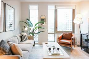 a living room with a couch and a chair and a table at The Lively, Jersey City New Jersey