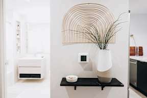 a black shelf with a vase and a plant in a bathroom at The Lively, New Jersey