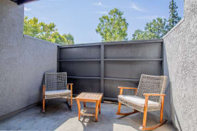 Patio with two chairs and coffee table at Banbury Apartments Riverside