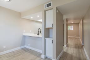 a kitchen with white cabinets and a white counter top