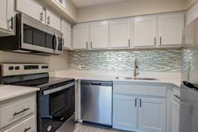 a kitchen with white cabinets and stainless steel appliances  at Sofia Apartments, Tempe, AZ, 85283