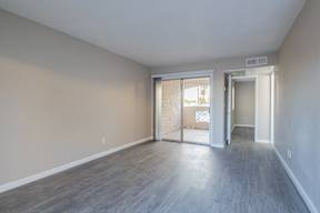 a bedroom with hardwood floors and beige walls  at Sofia Apartments, Tempe, AZ