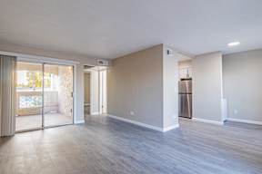 an empty living room with a sliding glass door to a patio  at Sofia Apartments, Arizona at Sofia Apartments, Tempe, 85283