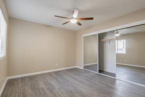 a bedroom with hardwood floors and a ceiling fan  at Sofia Apartments, Arizona