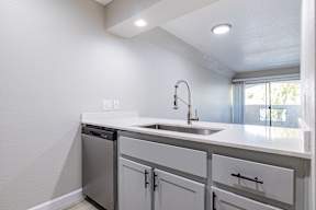 A white kitchen with a sink and a dishwasher at Sofia Apartments, Tempe, 85283