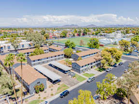 an aerial view of a city with buildings and a parking lot