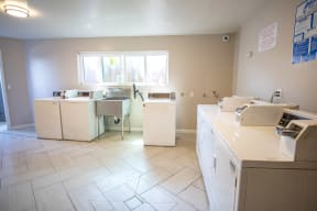 an empty kitchen with appliances and a window