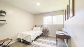 a bedroom with a bed and a window