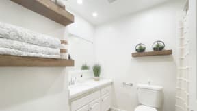 a bathroom with a toilet sink and mirror