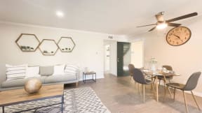 a living room with a couch a table and a clock