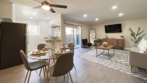 a dining room and living room with a table and chairs