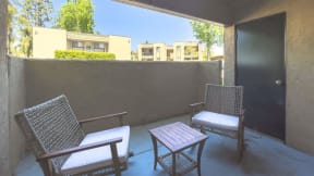 a patio with two chairs and a table