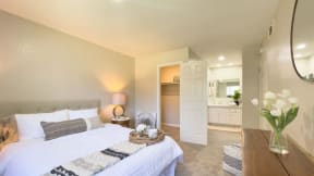 a bedroom with a large bed next to a bathroom