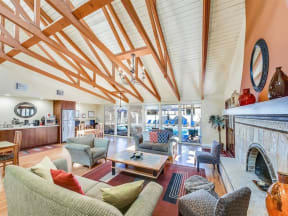 a living room with a fireplace and wooden beams on the ceiling