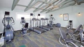a room filled with lots of different types of exercise equipment