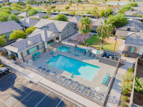an aerial view of a swimming pool and a house with a pool and chairs at Villas on Olive, Peoria, Arizona