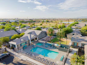 a group of houses with a swimming pool and patio furniture at Villas on Olive, Peoria, Arizona