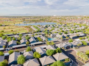an aerial view of a neighborhood with many houses and a pond at Villas on Olive, Peoria, Arizona