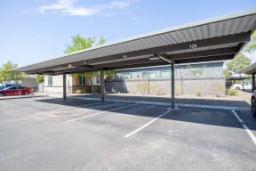 an empty parking lot with a canopy in front of a building at Villas on Olive, Peoria, Arizona