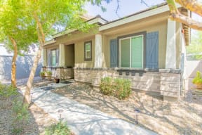 a house with green shutters and a sidewalk in front of it at Villas on Olive, Peoria, Arizona