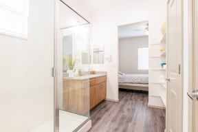 a bathroom with a shower and a sink and a bedroom at Villas on Olive, Peoria, Arizona 85345